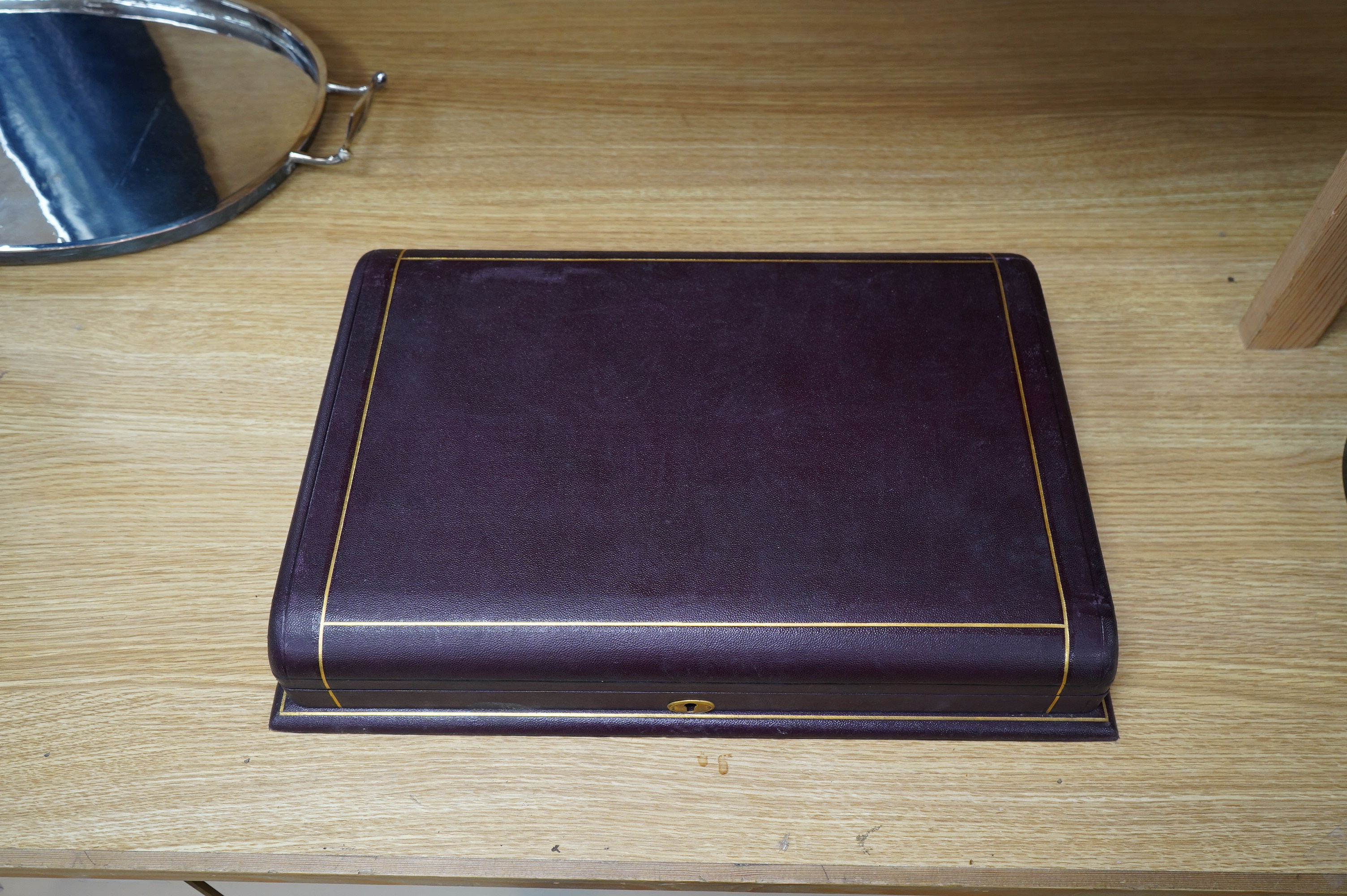 A gilt tooled leather cased stag handled silver collared carving set, case 44cm wide. Condition - good